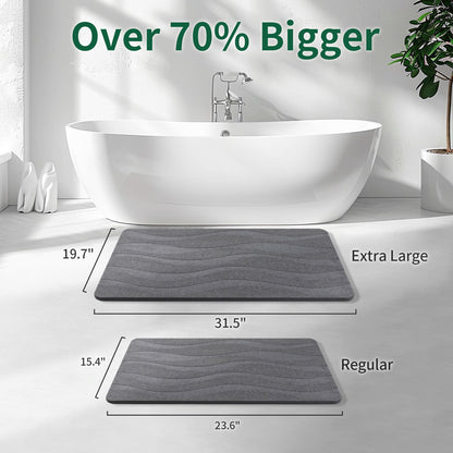 Extra-large gray stone bath mat compared with regular mat in a bathroom.
